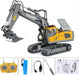 Grey and yellow toy excavator with remote control and accessories.