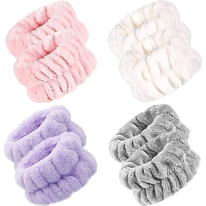 Four sets of fluffy wrist towels in pink, white, purple, and gray arranged on a white background.