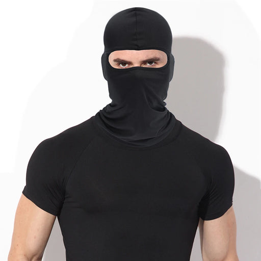 A man wearing a black balaclava with only his eyes visible, posing against a white background.