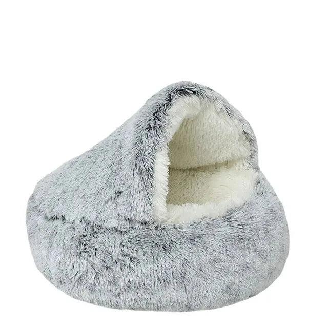 An empty light grey fluffy pet bed with a dome-shaped opening, highlighting its soft and cozy design.