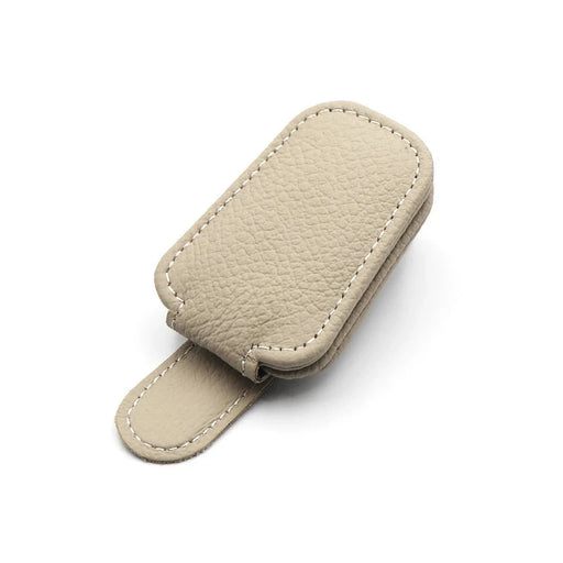 Beige leather clip with a magnetic closure, lying flat.