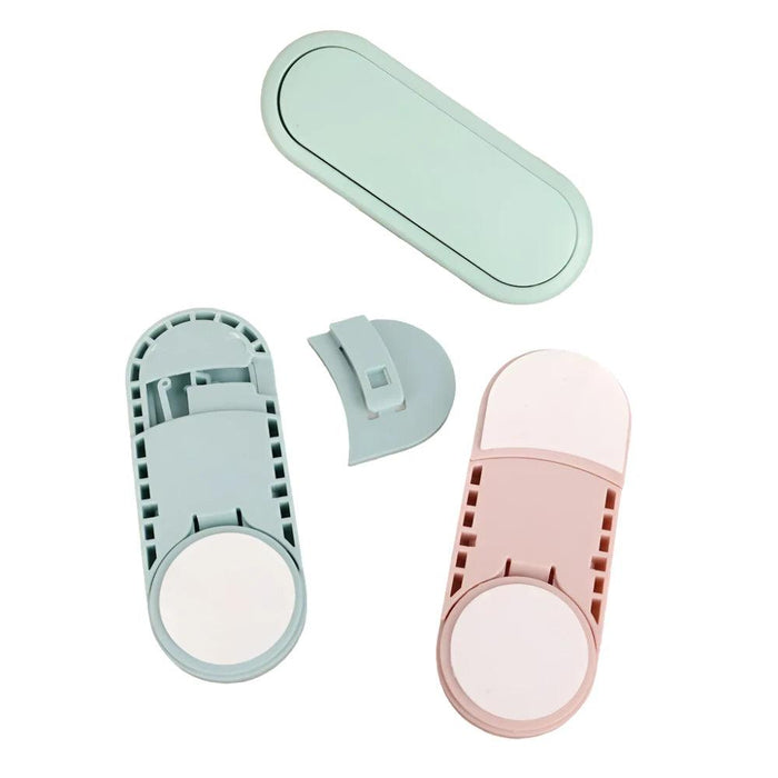 three child safety locks in mint green, light blue, and pink, disassembled to show their components. Each lock consists of a main body with an adhesive pad and a separate locking mechanism, indicating that they are easy to install and use.