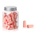 A jar filled with pink earplugs. With 2 pink earplugs beside it.