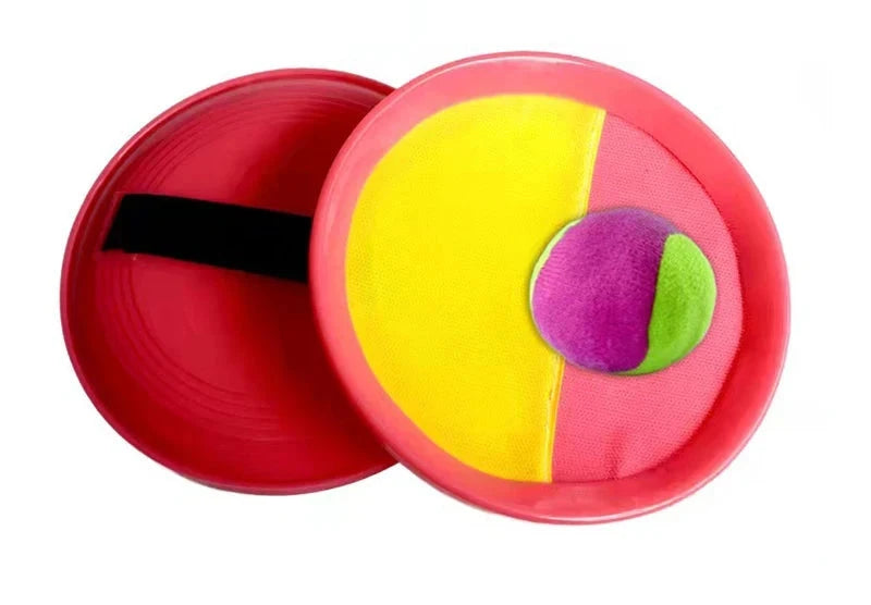 Red pink and yellow Velcro catch paddle with blue and green sections, paired with a pink and green ball.