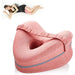 Pink knee pillow for side sleepers with a woman demonstrating its use.