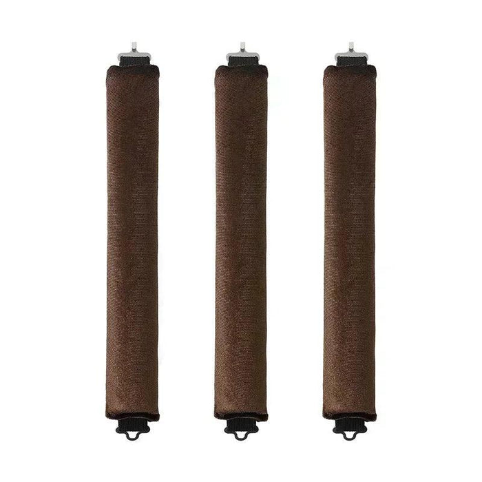 Three brown rod-shaped hair curlers in a row.