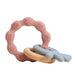 A pink silicone teether ring with blue various textured patterns and a wooden ring attached to it.