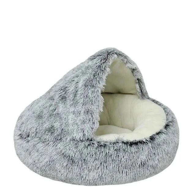 An empty, grey fluffy pet bed with a dome-shaped opening.