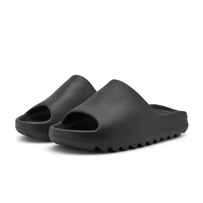 A pair of black Pillow Slides Slippers.