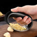 Stainless Steel Garlic Crusher crushing garlic