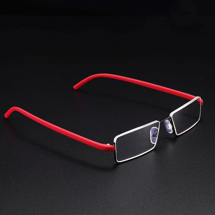 A pair of rectangular eyeglasses with silver frames and red temples is set against a dark background. The glasses have a modern, minimalist design with clear lenses.