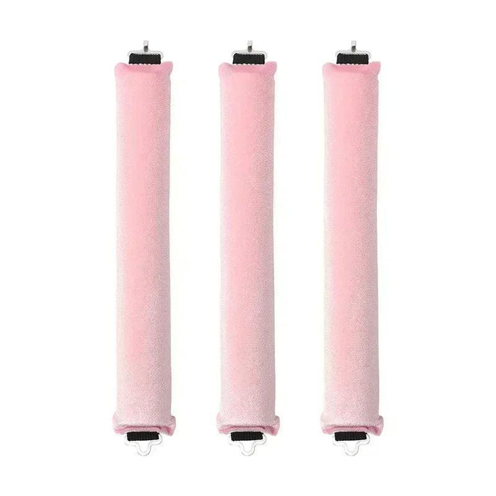 Three pink rod-shaped hair curlers in a row.