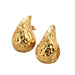 a pair of teardrop-shaped gold earrings with a textured, hammered surface. The uneven texture adds a unique, artisanal touch to the earrings, making them stand out.