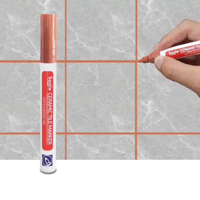 A red ceramic tile marker in use on a marble-like tile surface, clearly defining grout lines for a polished and clean finish.