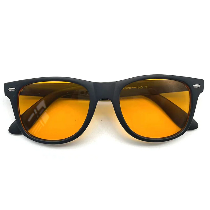 Folded black-framed sunglasses with orange-tinted lenses on a white background.