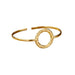 Gold cuff bracelet with a textured circle design, displayed on a white background.