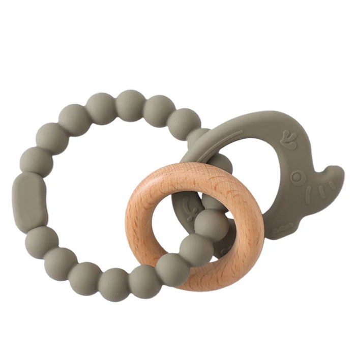 A teething ring set with gray silicone beads, a wooden ring, and a gray silicone elephant-shaped charm.