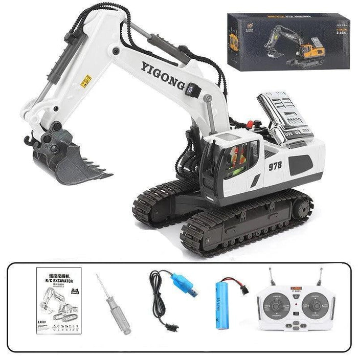 White and grey toy excavator with remote control and accessories.