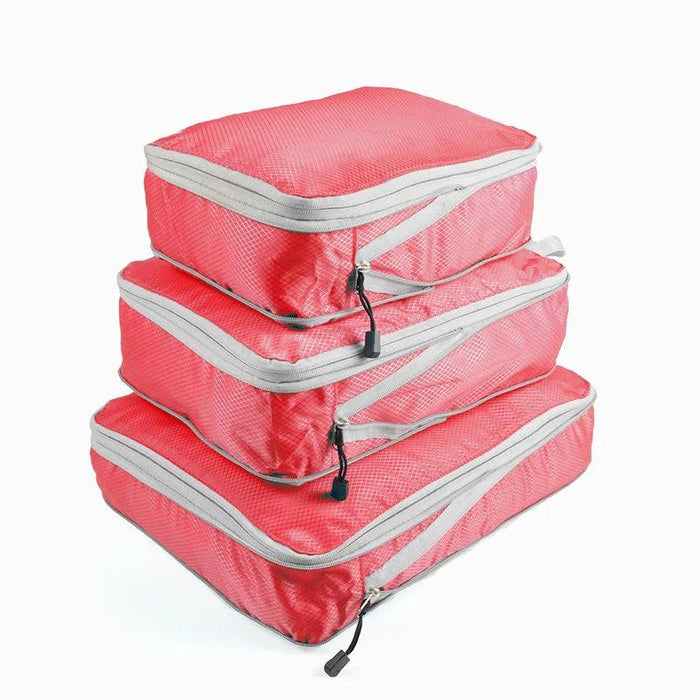 Three red packing cubes with gray zippers and handles, stacked on top of each other. Each cube has a zipper pull with a black tab.