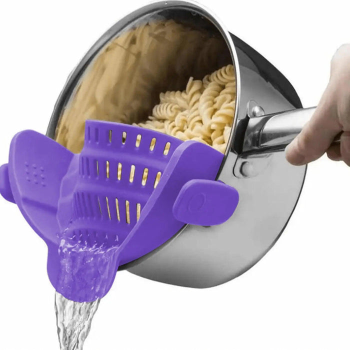 A person pours water from a pot full of pasta with a purple clips that holds the pasta so it doesn't fall and allows the water to escape. Ideal for simple food preparation.