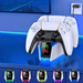 A PlayStation 5 controller resting on a charging station. The station has a futuristic design with a translucent front display that shows a green and a red icon, indicating the charging status of two controllers. There are also multiple charging docks below in various colors: green, red, purple, blue, and yellow, each with an icon that resembles a game controller.