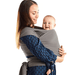 A contented mother is shown holding her cheerful baby in a stylish wrap sling. The sling is a sophisticated gray. The baby, appearing happy and comfortable, is nestled closely against her, highlighting the sling's functionality for keeping the baby close and secure while supporting the mother's mobility and comfort. This image beautifully captures the intimate and loving bond between the mother and her infant.