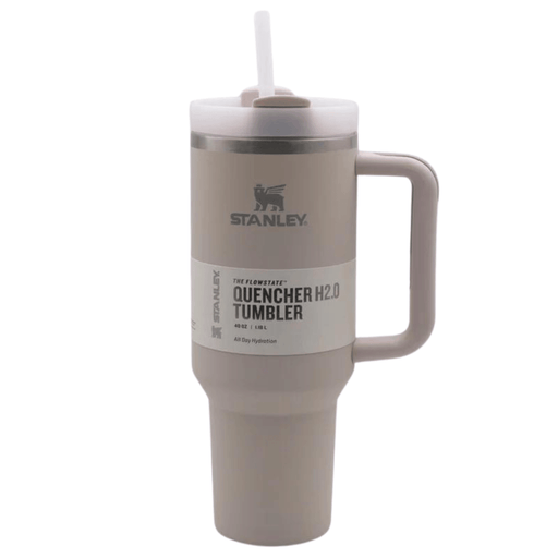 Stanley Quencher H2.0 Tumbler in taupe with a matching handle and white straw, displayed on a white background. This 40 oz insulated tumbler features the Stanley logo and is designed for effective use.